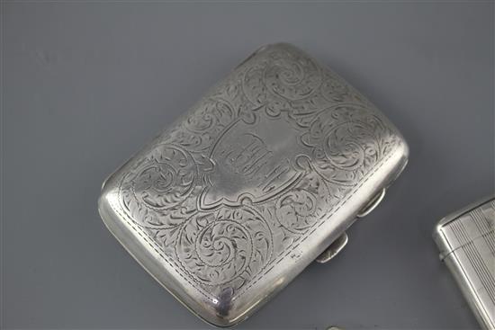 An Edwardian engraved silver cigarette case, Samuel M. Levi, Birmingham, 1905 and two similar vesta cases,